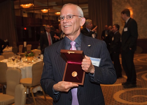 Peter Trefonas gives other guests a peek at the SCI Perkin Medal after the award ceremony. This award is considered the highest honor in the US chemical industry.